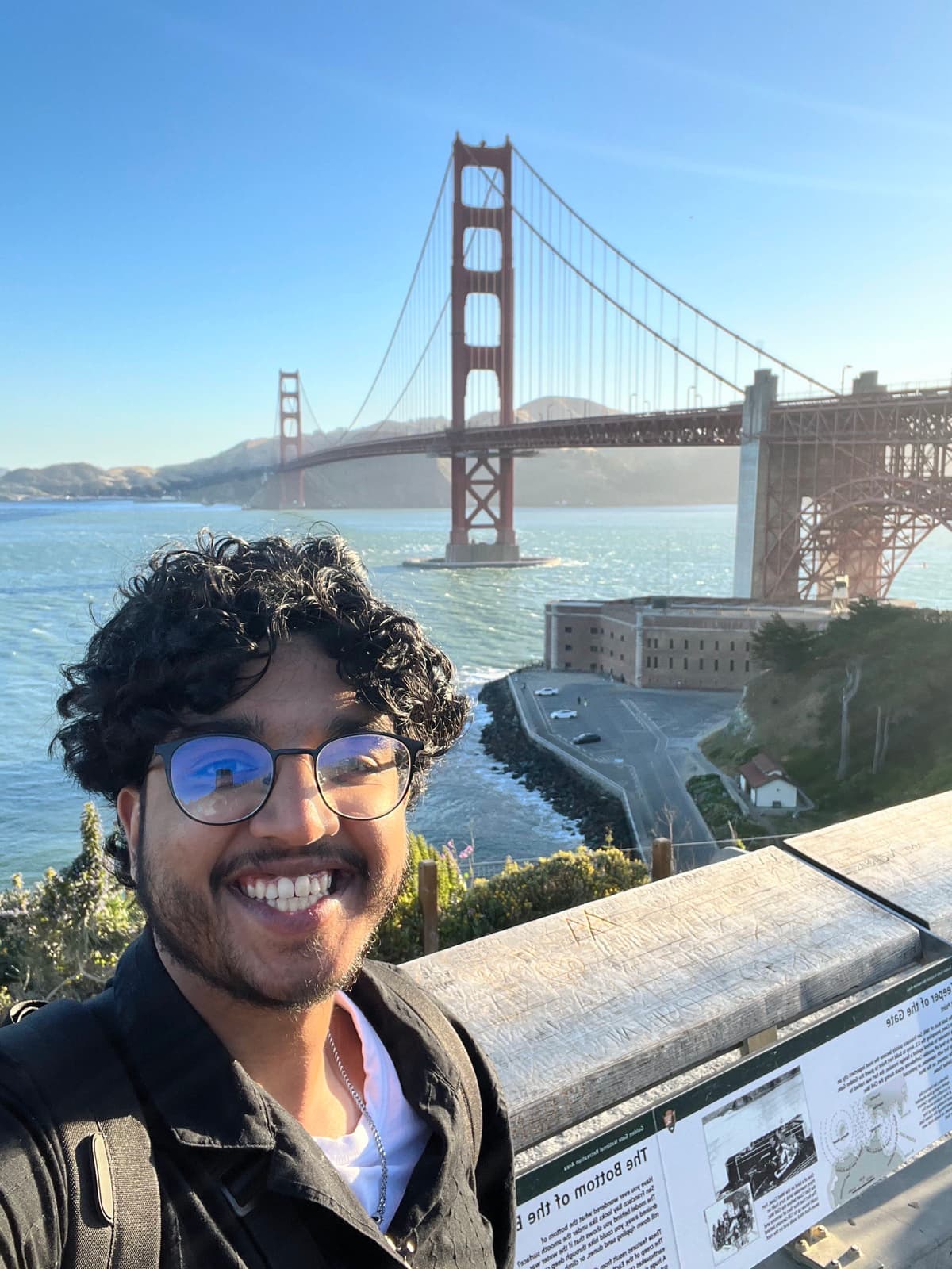 Colin smiling in front of the Golden Gate Bridge